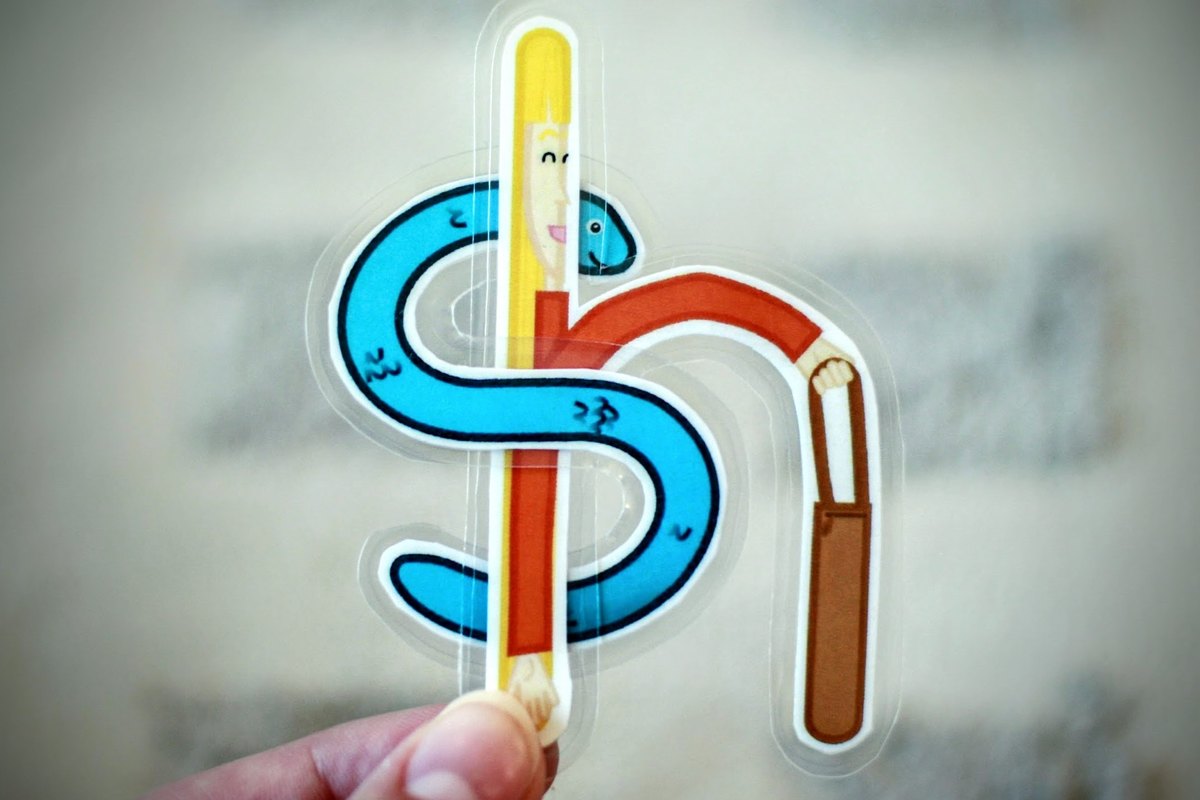 Holding up a translucent mnemonic S letter card